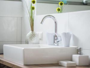 a white sink with a vase on top of it at 2 in holiday home Sandra in Hörbranz