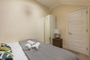 a bedroom with a bed with towels on it at Modern 1 Bed Attic Apartment in Brixton in London