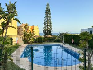 a swimming pool with a fence around it at Casa Lince: 2/2 in Marbella in Marbella