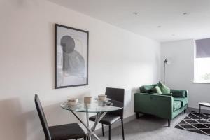 a living room with a glass table and a couch at Cosy & Modern 1 Bed Apartment Leeds in Leeds