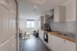 a kitchen with a sink and a counter at Lovely 1 Bedroom Apartment Leeds in Leeds