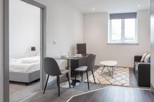 a room with a table and chairs and a bed at Lovely 1 Bedroom Apartment Leeds in Leeds