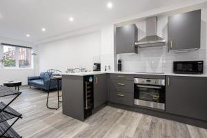 a kitchen with stainless steel appliances and a living room at Fantastic 1 Bedroom Apartment in Preston Centre in Preston