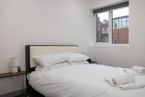 a white bed with white pillows and a window at Fantastic 1 Bedroom Apartment in Preston Centre in Preston