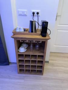 a small wooden table with a coffee maker on it at Ononui Airport Studio in Faaa