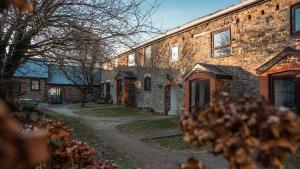 a large brick building with a pathway in front of it at Lovely 3 Bedroom Holiday Cottage nr Bude in Bude