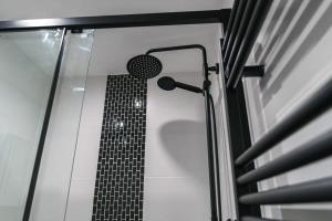 a shower in a bathroom with a black and white at Lovely 1 Bedroom Apartment in Preston in Preston