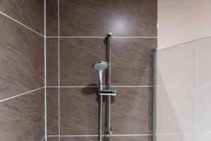 a shower with a shower head in a bathroom at Modern 2 Bed Apartment in Manchester - Sleeps 4 in Manchester