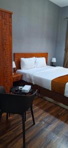 a hotel room with two beds and a desk and a bed at Arabian Hotel Apartments in Ajman 