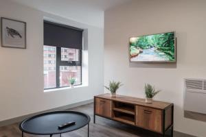 a living room with a tv on a wall at Modern 1 Bed Apartment in Liverpool Centre in Liverpool