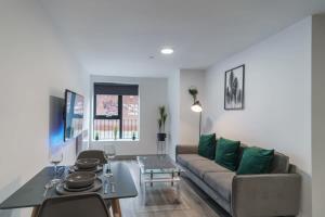a living room with a couch and a table at Lovely 1 Bed Apartment in Central Liverpool in Liverpool