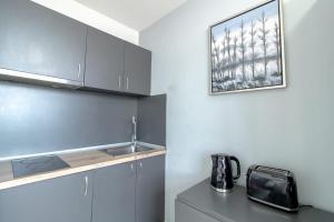 a kitchen with a sink and a microwave at Lovely Budget Sunderland Studio with Great Views in Sunderland