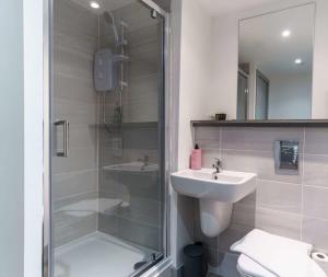 a bathroom with a shower and a sink and a toilet at Lovely 1 Bed Apartment in Central Liverpool in Liverpool