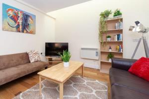 a living room with a couch and a coffee table at Characterful 2 Bedroom Apartment in Brixton in London