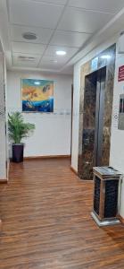 an empty room with a potted plant in a building at Arabian Hotel Apartments in Ajman  +22 photos