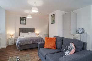 a living room with a couch and a bed at Modern Studio Apartment in Central Liverpool in Liverpool