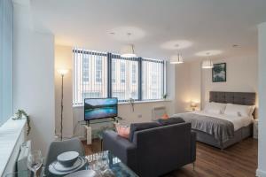 a living room with a bed and a couch at Modern Studio Apartment in Central Liverpool in Liverpool
