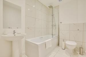 a white bathroom with a sink and a toilet at Modern 2 Bedroom Apartment in Burnley in Burnley