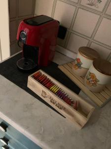 a counter with a coffee pot and a box of matches at Stefy House in Ravenna