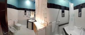 a bathroom with a sink and a toilet and a shower at Casa Ale in Avola +3 photos