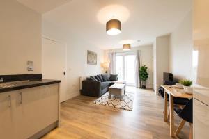 a kitchen and living room with a couch and a table at Fantastic 1 Bed Apartment in Crawley in Crawley