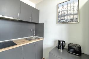 a kitchen with a sink and a counter top at Charming Budget Studio in Central Sunderland in Sunderland