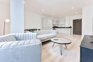 a living room with a couch and a table at Modern and Stylish 2 Bed Apartment in Solihull in Birmingham