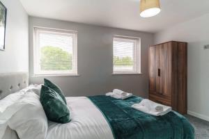 a bedroom with a bed with two towels on it at Modern 2 Bedroom Apartment in Liverpool in Liverpool