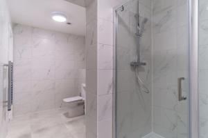 a bathroom with a shower with a glass door at Contemporary 1 Bedroom Apartment in Liverpool in Liverpool