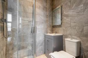 a bathroom with a shower and a toilet and a sink at Modern and Cosy Budget Studio in Central Doncaster in Doncaster