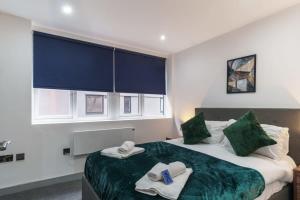 a bedroom with a bed with towels on it at Fantastic 1 Bedroom Apartment in Preston in Preston