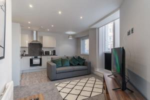 a living room with a couch and a tv at Fantastic 1 Bedroom Apartment in Liverpool in Liverpool