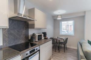 a kitchen with a counter top and a table at Fantastic 1 Bedroom Apartment in Liverpool in Liverpool