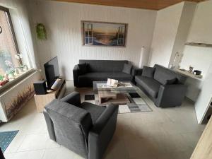 a living room with a couch and a table at Ferienhaus Gomann in Dornum