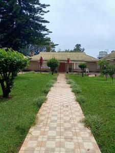 a brick path in front of a house at Nick's and Essy's place in Juja