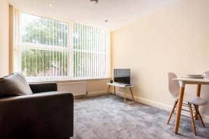 a living room with a couch and a table at Bright 1 Bedroom Budget Flat in Central Pontefract in Pontefract