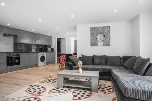 a living room with a couch and a table at Modern 2 Bedroom Apartment in Central Woking in Woking