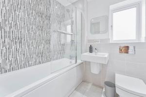 a white bathroom with a sink and a shower at Modern 1 Bedroom House in Burton-on-Trent in Burton upon Trent