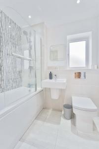 a white bathroom with a toilet and a sink at Modern 1 Bedroom House in Burton-on-Trent in Burton upon Trent