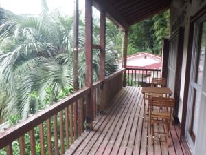 a wooden porch with two chairs and a table at Kajikaen - Vacation STAY 57948v in Kawazu