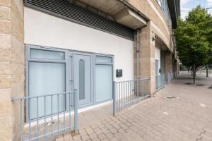 two garage doors on the side of a building at Lovely 1 Bedroom Apartment in Woking Centre in Woking