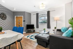 a living room with a couch and a table at Spacious 1 Bedroom Apartment in Central Woking in Woking