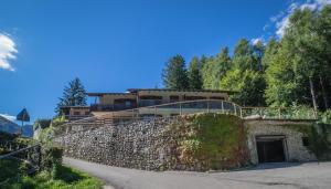 a building on top of a stone wall at Residence Panorama in Molina di Ledro