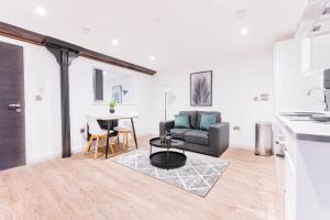 a living room with a couch and a table at Spacious 1 Bed Apartment in Burton-on-Trent in Burton upon Trent