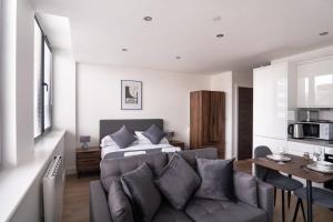 a living room with a couch and a bed at Cosy Studio Apartment by Old Trafford in Manchester