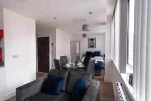 a living room with a couch and a dining room at Fantastic Studio Apartment by Old Trafford in Manchester