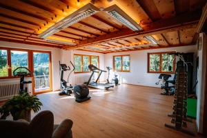a gym with treadmills and exercise bikes in a room at Hotel Sperlhof in Windischgarsten