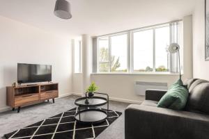 a living room with a couch and a tv at Contemporary 1 Bed Apartment in Central Retford in Retford