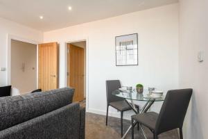 a living room with a table and a couch at Modern 2 Bedroom Apartment in Central Hull in Hull