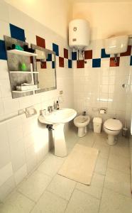 a bathroom with a sink and a toilet at Ferienhaus Casa Oliva - Villaggio Galanu in Costa Paradiso +16 photos